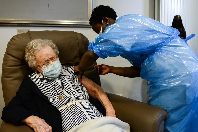 Lucie Danjou, 101, receives a dose of the Pfizer-BioNtech COVID-19 vaccine at the Notre-Dame hospital in Brussels, Belgium. AFP