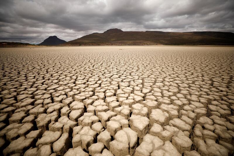 Clouds gather but produce no rain as cracks are seen in the dried up municipal dam in drought-stricken Graaff-Reinet, South Africa. Reuters