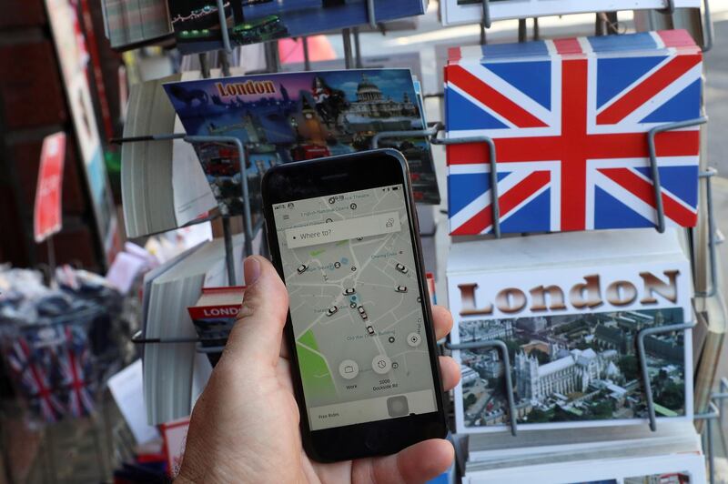 FILE PHOTO: A photo illustration shows the Uber app and London themed postcards in London, Britain June 26, 2018. REUTERS/Simon Dawson/Illustration/File Photo