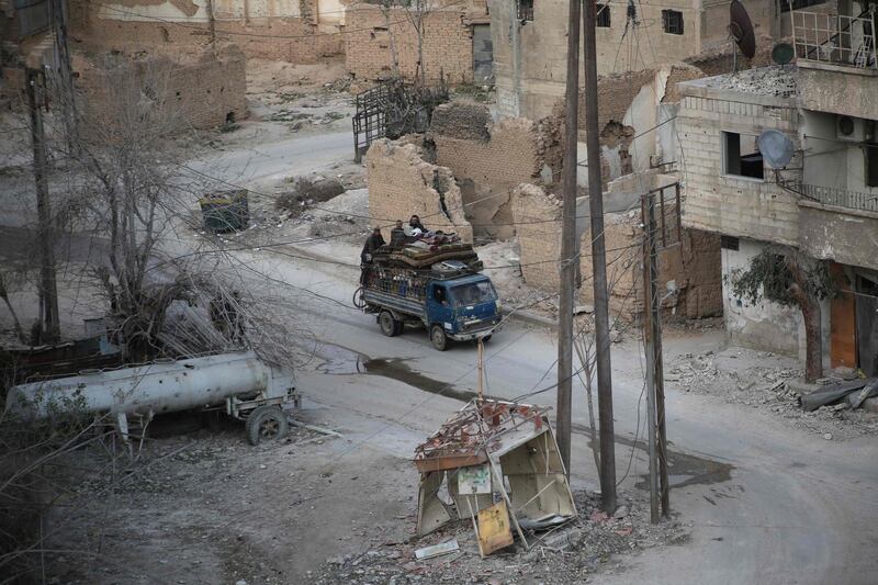 Syrian civilians carry their belongings on the back of a pick up truck as they flee following government bombardment on Kafr Batna, in the besieged Eastern Ghouta region on the outskirts of the capital Damascus on March 10, 2018. Ammar Suleiman / AFP