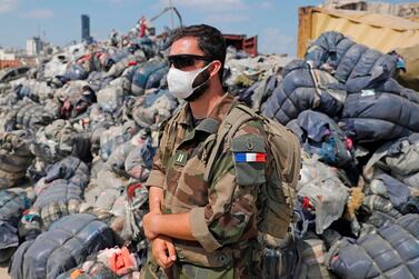 A French soldier stands guard at Beirut port on August 26, 2020 as French and Lebanese troops clear rubble and debris from a massive explosion earlier this month. AFP