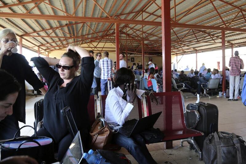 Locals and foreign nationals gather at Juba International Airport as they wait for flights out of the South Sudanese capital. REUTERS/Hakim George