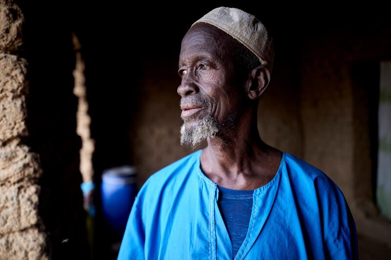 Amadou Diakite, 75, poses in a courtyard of Sevare after fleeing his village of Guerri in central Mali, on February 27, 2020.  In January 2019 Jihadists broke in the village, setting fire on it, killing 3 villagers, and stealing all the livestock. AFP