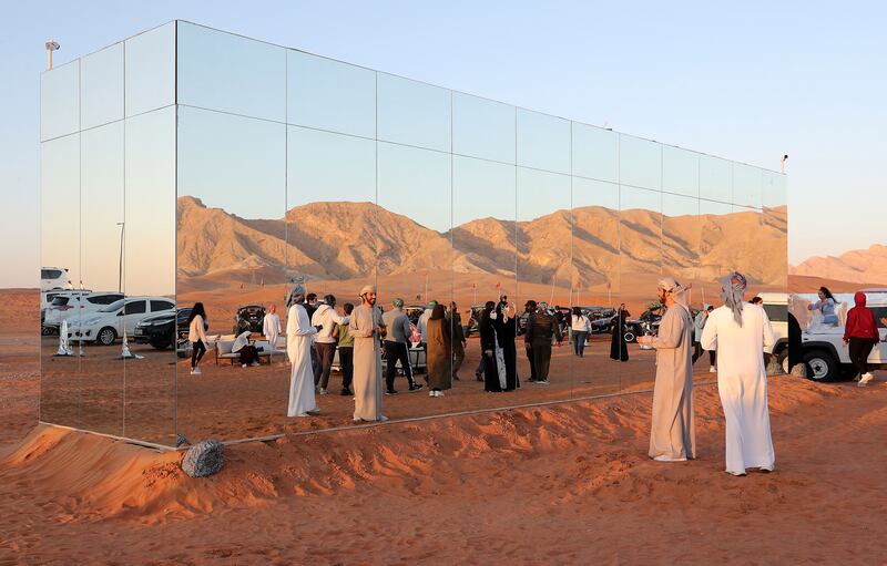 Guests take photos of the mirrored kitchen.