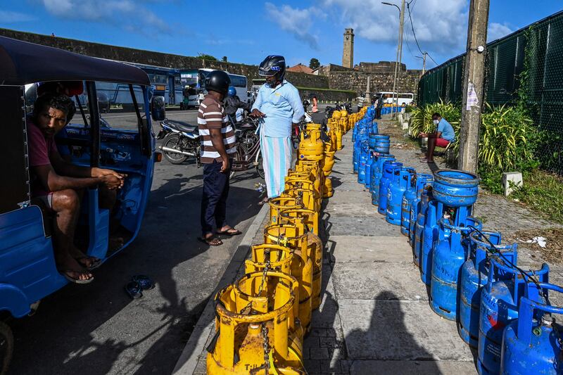 People buy liquefied petroleum gas (LPG) cylinders near the Galle International Cricket Stadium in southern Sri Lanka. AFP
