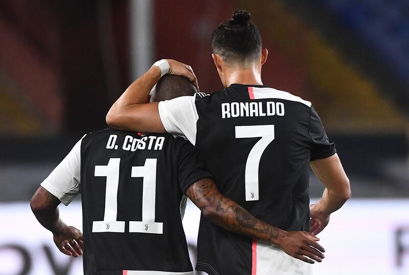 Douglas Costa celebrates with his teammate Cristiano Ronaldo after scoring Juventus' third goal. EPA
