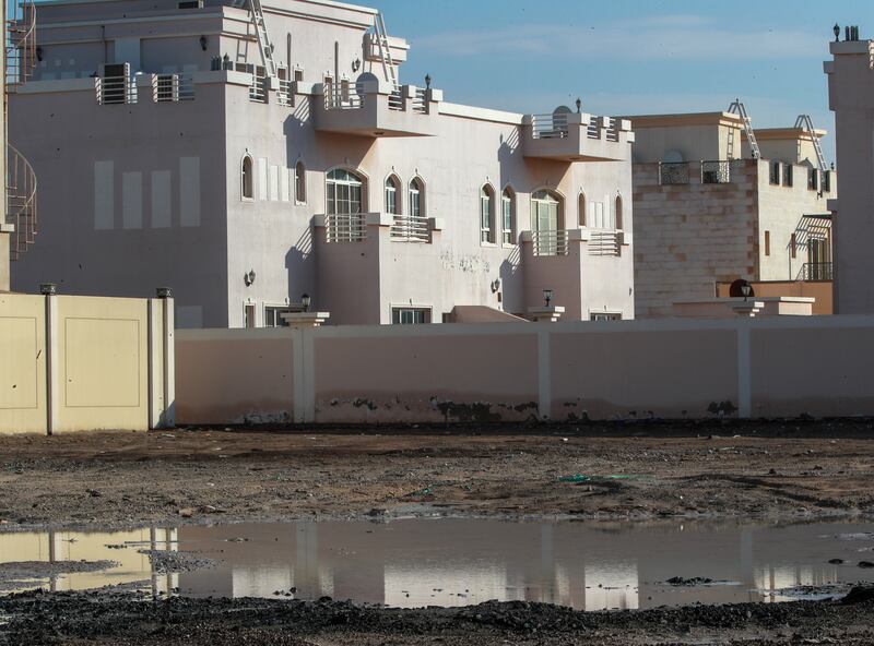 Floodwater creeps between homes in Khalifa City, Abu Dhabi. Victor Besa / The National