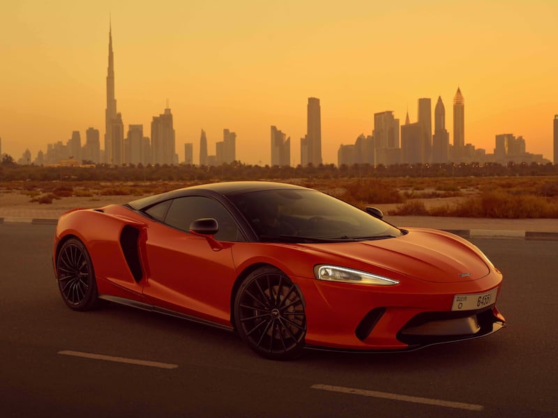 A GT at dusk, before the Dubai skyline.