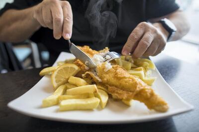 A customer cuts a cod on a plate of fish and chips at a restaurant in Deal, U.K., on Thursday, Oct. 15, 2020. Germany put pressure on France to back down on its demands over fishing, one of the biggest obstacles to a post-Brexit trade deal with the U.K., as Boris Johnson warned he is disappointed about the progress of the negotiations. Photographer: Chris Ratcliffe/Bloomberg via Getty Images