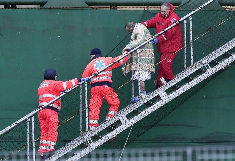 An injured passenger is helped off the Spirit of Piraeus cargo ship at Bari, Italy, on Monday. More than 400 passengers and crew were rescued from the Greek ferry that caught fire. Yara Nardi / Reuters