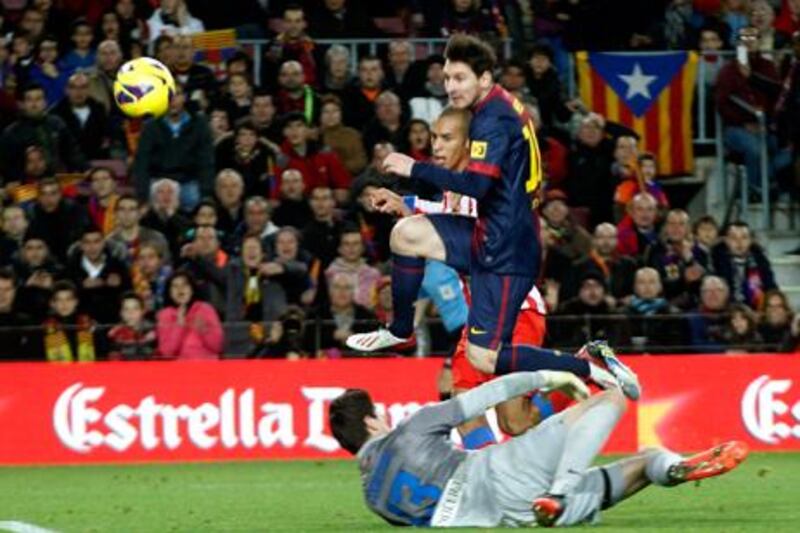 Barcelona's Lionel Messi scores his second against Atletico Madrid.