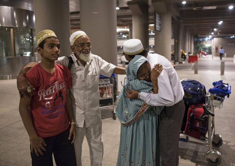 An Indian evacuee from Yemen hugs her son after arriving at the international airport in Mumbai. Danish Siddiqui / Reuters