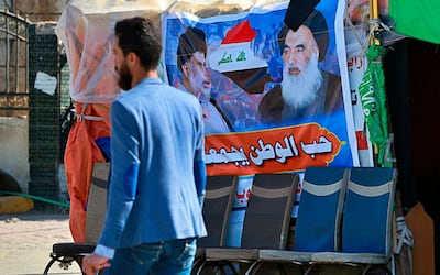 FILE - In this Sunday, Feb. 2, 2020 photo, a poster of Shiite spiritual leader Grand Ayatollah Ali al-Sistani, right, and Arabic that reads, "the love of the country bonds us together," is seen in Najaf, Iraq. Iraqâ€™s top Catholic official said Thursday, Jan. 28, 2021 that a deadly suicide bombing in Baghdad hasnâ€™t thwarted Pope Francisâ€™ plans to visit, and he confirmed the pontiff would meet with the countryâ€™s top Shiite cleric, Ali al-Sistani, in a significant highlight of the first-ever papal trip to Iraq. The Chaldean patriarch, Cardinal Louis Raphael Sako, provided the first details of Francisâ€™ March 5-8 itinerary during a virtual press conference hosted by the French bishops' conference. (AP Photo/Hadi Mizban, File)