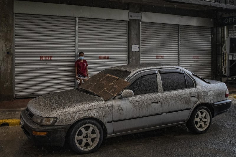 A vehicle covered in ash mixed with rainwater. Getty Images