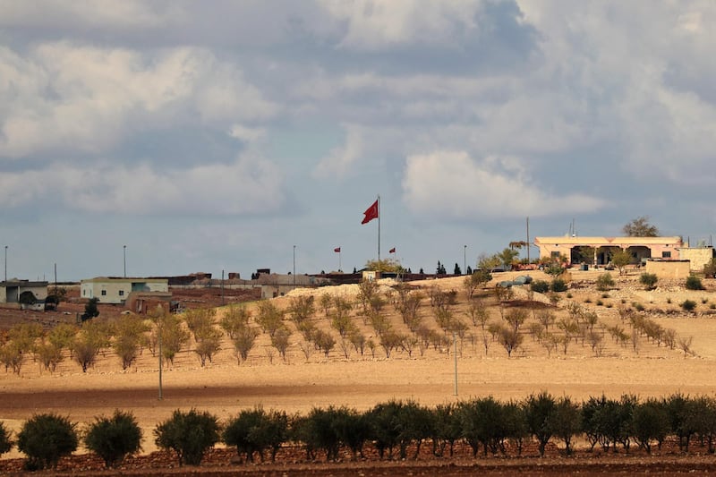 A general view shows a Turkish flag is flying at a military post in the countryside  village of Ashma in the Kurdish city of Kobane in northern Syria on November 8, 2018. In recent days, cross-border Turkish artillery fire has targeted positions held by the People's Protection Units (YPG), the main Kurdish militia in Syria. Ankara sees the de-facto autonomous rule set up by Syrian Kurds as an encouragement to the separatists of the Turkey-based Kurdistan Workers' Party (PKK), which has close ties to the YPG. / AFP / DELIL SOULEIMAN

