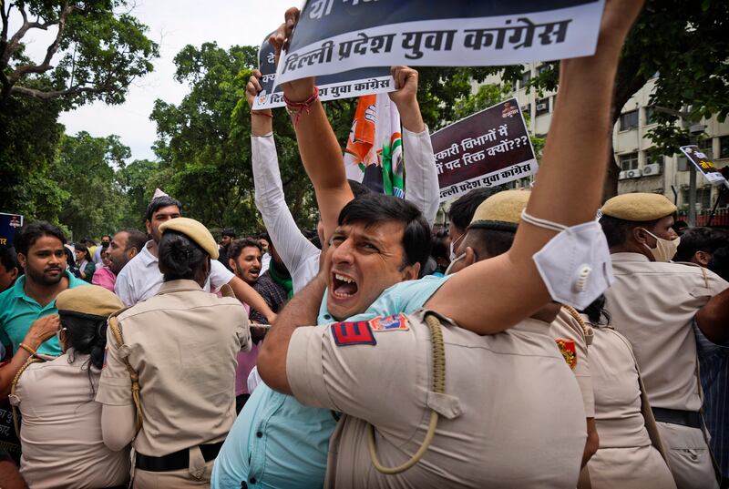 A policeman detains an Indian Youth Congress member in New Delhi. AP