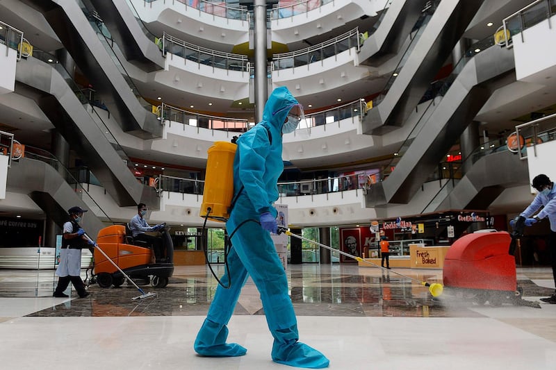 A worker sanitises the floor of a shopping mall reopened after the government eased a nationwide lockdown imposed as a preventive measure against the Covid-19 coronavirus, in Chennai on September 1, 2020.   / AFP / Arun SANKAR                        
