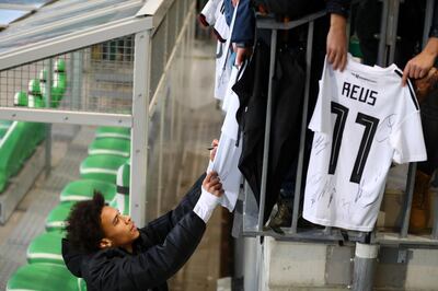 WOLFSBURG, GERMANY - MARCH 18: Leroy Sane of Germany signs autographs during a Germany international training session ahead of their international friendly against Serbia at AOK Stadium on March 18, 2019 in Wolfsburg, Germany. (Photo by Martin Rose/Bongarts/Getty Images)