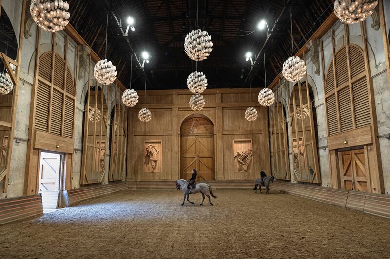 A horsewoman practices with her horse in the stables' riding arena of the royal stables, in Versailles. AP