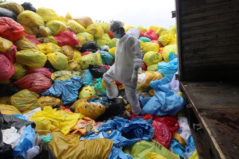 A worker wearing Personal Protective Equipment (PPE) stands over bags of disposed medical waste inside a hospital in Mumbai, India on August 11, 2020. India is the third worst-hit nation by the Coronavirus (COVID-19) pandemic after the United States and Brazil. (Photo by Himanshu Bhatt/NurPhoto via Getty Images)