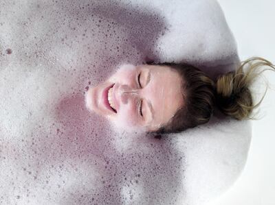 Woman in bubble bath, Glasgow, Scotland