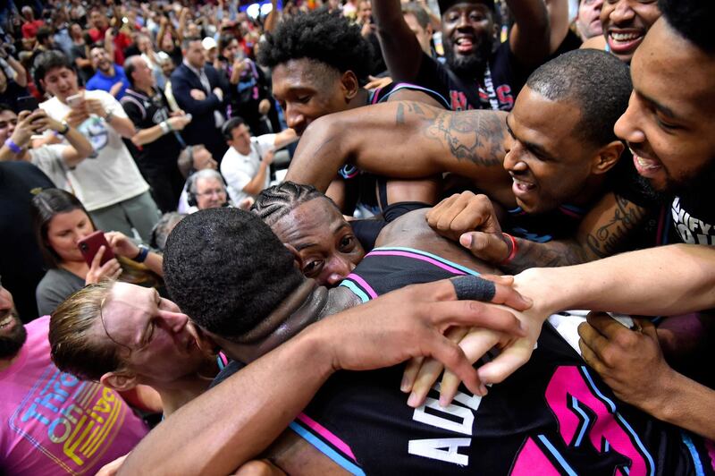 Miami Heat guard Dwyane Wade is mobbed my teammates after making the game winning basket during an NBA game against the Golden State Warriors in Miami. Reuters