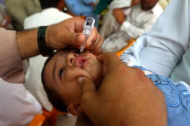 A health worker administers polio vaccine to children during a three-day countrywide vaccination campaign in Peshawar, Pakistan. EPA