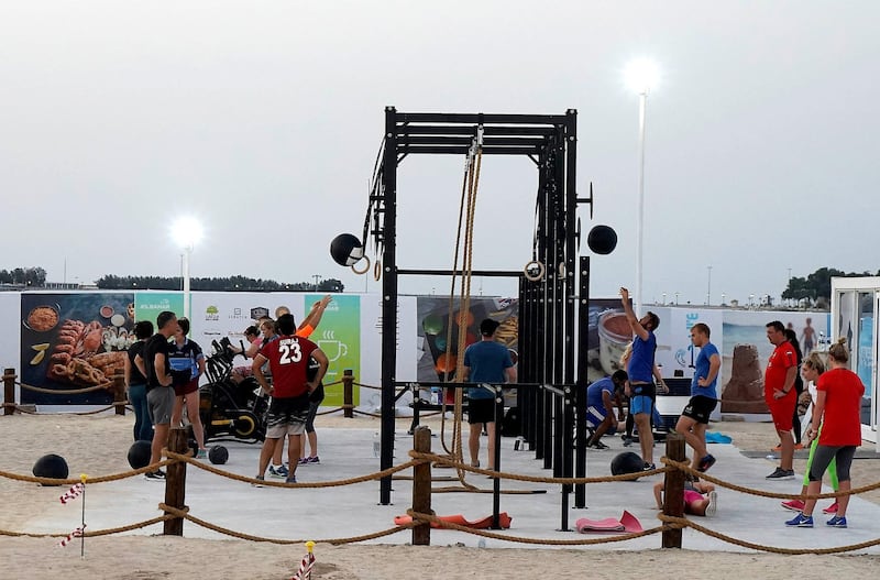                ABU DHABI , UNITED ARAB EMIRATES , APRIL 16   – 2018 :- People doing exercise in the open gym at the Al Bahar at the corniche in Abu Dhabi. ( Pawan Singh / The National ) For Weekender                 