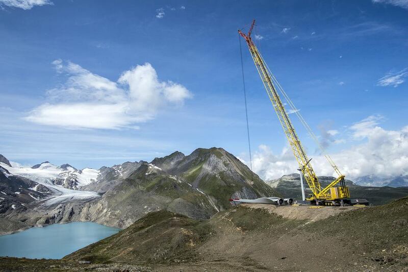 A crane works at the construction site of the highest wind park in Europe. Olivier Maire / EPA