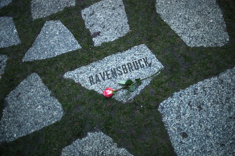 BERLIN, GERMANY - JANUARY 29:  A flower lies at a stone that refers to the former Ravensbrueck concentration camp at the Memorial to the Sinti and Roma Victims of National Socialism following a commemoration ceremony on January 29, 2018 in Berlin, Germany. The ceremony paid tribute to the estimated 220,000 to 500,000 Sinti and Roma victims, also called Gypsies, who died at the hands of the Nazis during the Holocaust. Ravensbrueck, located in central Germany, was primarily a concentration camp for women.  (Photo by Sean Gallup/Getty Images)