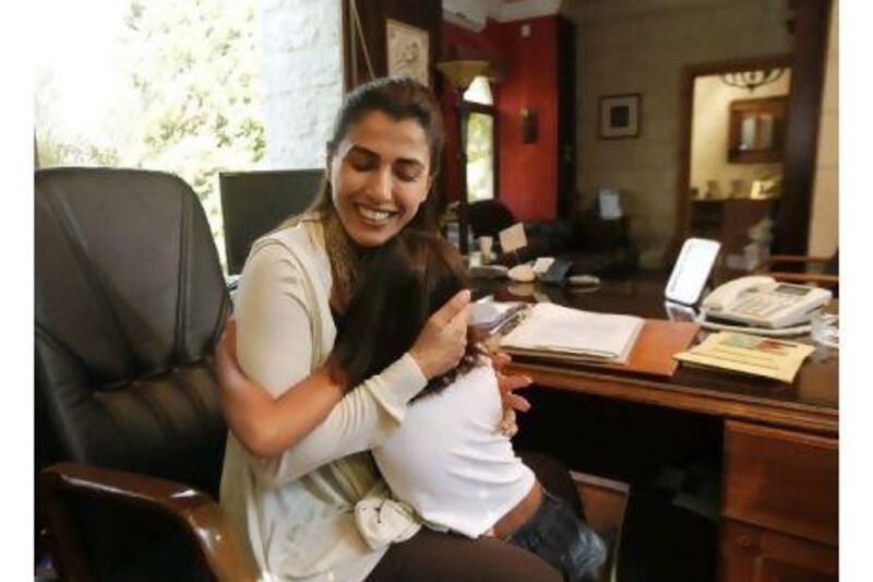 Jordanian parliament candidate Hind Al Fayez talks to her daughter Jawaher as she came to her mother's in-home office in Amman, Jordan.