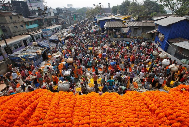 Vendors sell marigold garlands which are used to decorate temples and homes on the eve of Diwali in Kolkata, India. Reuters