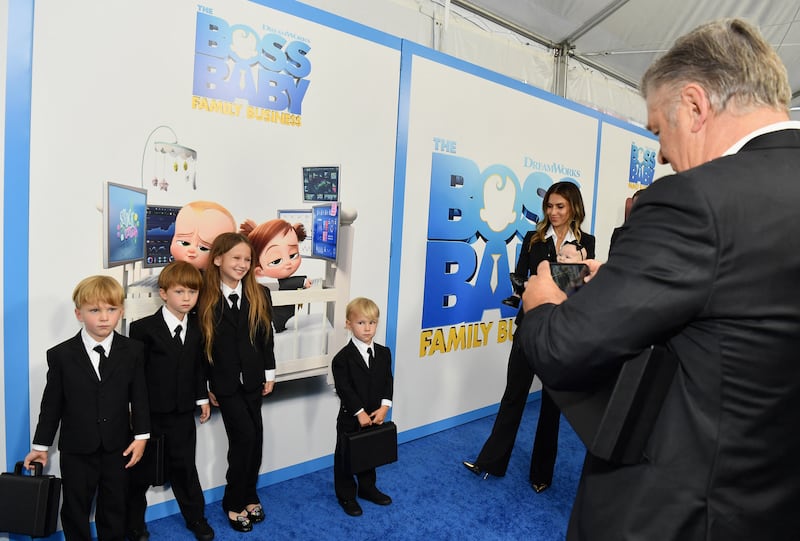 Actor Alec Baldwin takes a picture of his children as wife Hilaria Baldwin looks on, at the premiere of 'The Boss Baby: Family Business'. AFP