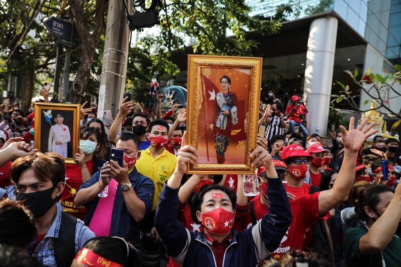 People hold up images of Myanmar's de-facto leader Aung San Suu Kyi at a protest outside Maynmar's embassy in Bangkok, Thailand. Getty Images