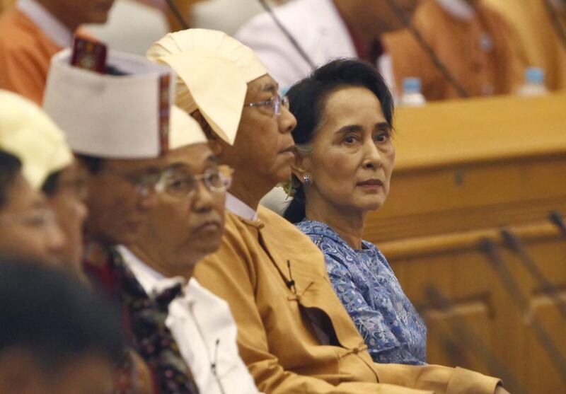 Aung San Suu Kyi and Htin Kyaw, second from right, attend a ceremony to take oaths in parliament in Naypyitaw, Myanmar. Aung Shine Oo / AP