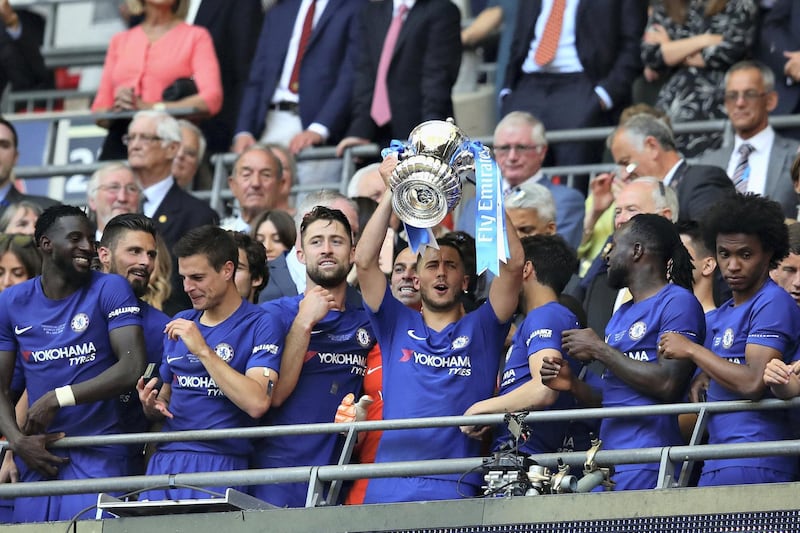 LONDON, ENGLAND - MAY 19: Eden Hazard of Chelsea lifts the FA Cup trophy after his side won during the Emirates FA Cup Final between Chelsea and Manchester United at Wembley Stadium on May 19, 2018 in London, England.  (Photo by Chris Brunskill Ltd/Getty Images)