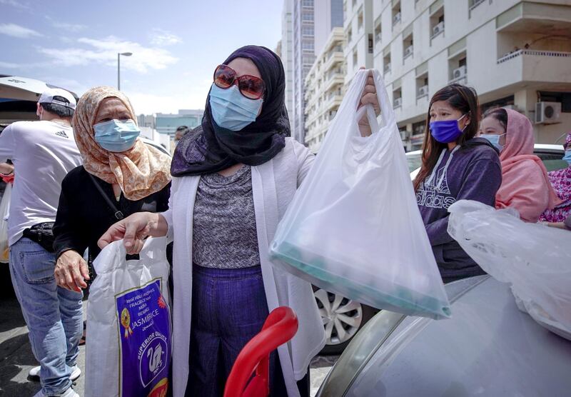 Abu Dhabi, United Arab Emirates, May 1, 2020.   
 Laid off Filipino Muslim workers with their rice, eggs, cooking oil and other daily essentials given to them by Filipino-Emirati woman, Mona Mohamed Baraguir at the residential area in front of Al Wahda Mall, on a Friday morning.
Victor Besa / The National
Section:  NA
Reporter:  Shireena Al Nuwais