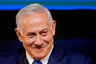Israeli Prime Minister Benjamin Netanyahu smiles as he addresses supporters at his Likud Party headquarters in Tel Aviv on election night early on April 10, 2019. AFP