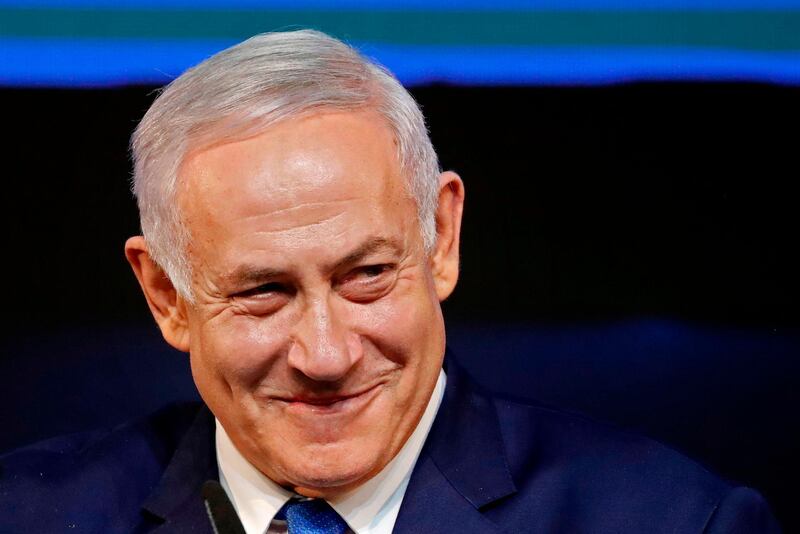 Israeli Prime Minister Benjamin Netanyahu smiles as he addresses supporters at his Likud Party headquarters in the Israeli coastal city of Tel Aviv on election night early on April 10, 2019. The results from yesterday's vote came despite corruption allegations against the 69-year-old premier and put him on track to become Israel's longest-serving prime minister later this year. / AFP / THOMAS COEX
