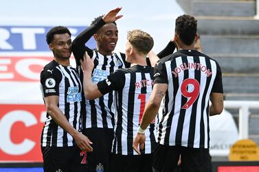 Newcastle's Joe Willock, second left, is congratulated by teammates after scoring his team's third goal during the English Premier League soccer match between Newcastle United and West Ham United at St James' Park, Newcastle, England, Saturday April 17, 2021. (AP Photo/Stu Forster/Pool)