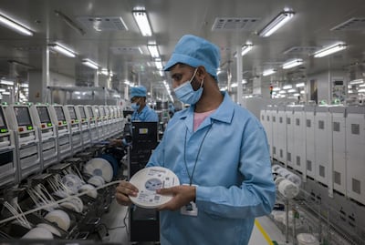 Workers at the surface mount technology workshop inside the Realme factory in Greater Noida, India. Photographer: Anindito Mukerjee / Bloomberg