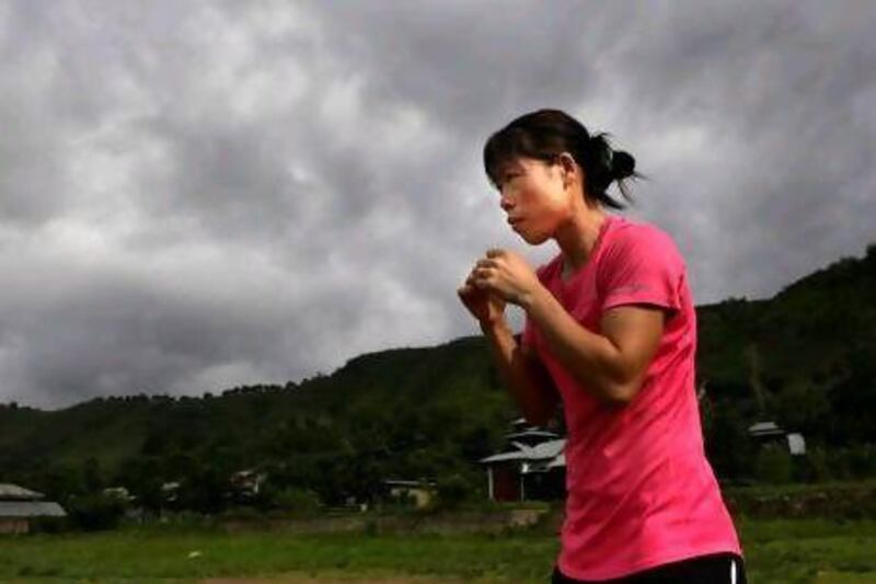 Mary Kom, a five-time world champion, practices boxing at her residence in Langol Games village on the outskirts of Imphal.