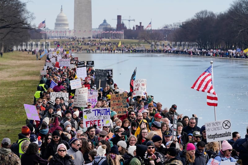 Protesters march alongside the Lincoln Memorial Reflecting Pool before an anti-vaccine rally in Washington, US. AP
