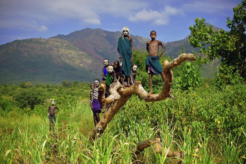 (FILES) This file photo taken on September 24, 2016 shows children from the Suri tribe posing in Ethiopia's southern Omo Valley region near Kibbish. 
More than 1.1 billion people worldwide officially don't exist -- going about their daily lives without proof of identity. The issue leaves a significant fraction of the global population deprived of health and education services, international organizations lament. Among these "invisible people" -- many of whom live primarily in Africa and Asia -- more than one-third are children susceptible to violence whose births have not been registered, the World Bank's "Identification for Development" (ID4D) program recently warned. / AFP PHOTO / CARL DE SOUZA