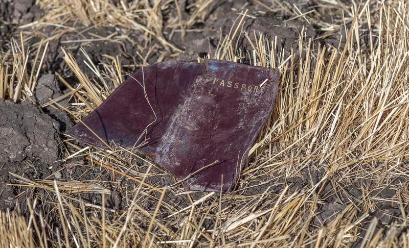 A passenger passport lies on the ground. AP Photo