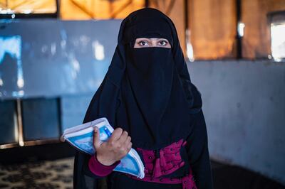 Rima with her study books in a Syrian refugee camp. Photo: Delil Souleiman / Unicef