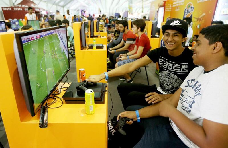 Young Emiratis test out the new Fifa 2016 video game at Games 15 Middle East at Dubai Marina on Saturday. Christopher Pike / The National