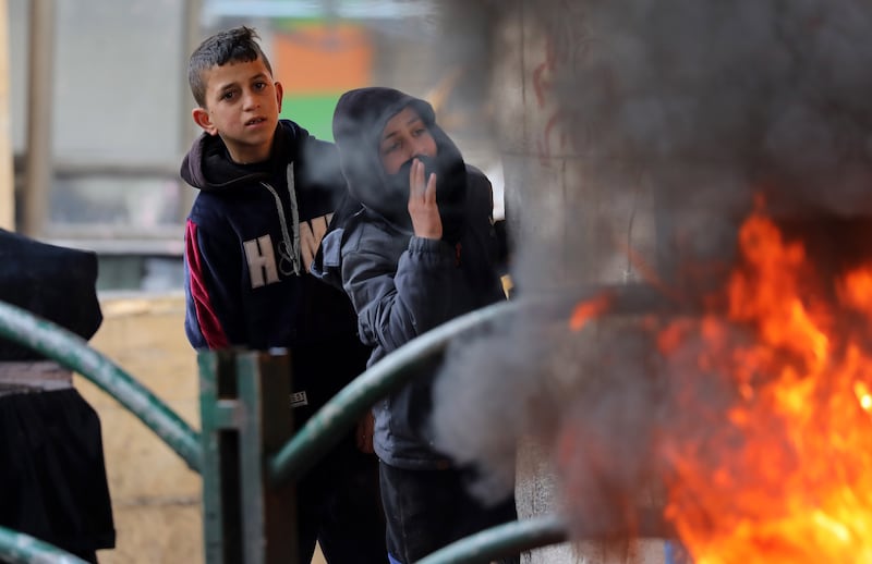 Palestinians burn tires during clashes with Israeli troops in the city of Hebron in the occupied West Bank. EPA