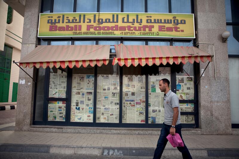 Abu Dhabi, United Arab Emirates, January 10, 2013: 
A man walks by the Babil Foodstuff Est., a recently closed convenience store on Thursday, Jan. 10, 2013, in the city block between Airport and Muroor, and Delma and Mohamed Bin Khalifa streets in Abu Dhabi. 
Silvia Razgova/The National

