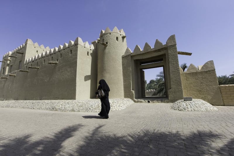 An Emirati woman walk past the Bin Hammoodah Al Dhaheri house in the Jimi Oasis during the first My Old House tour.